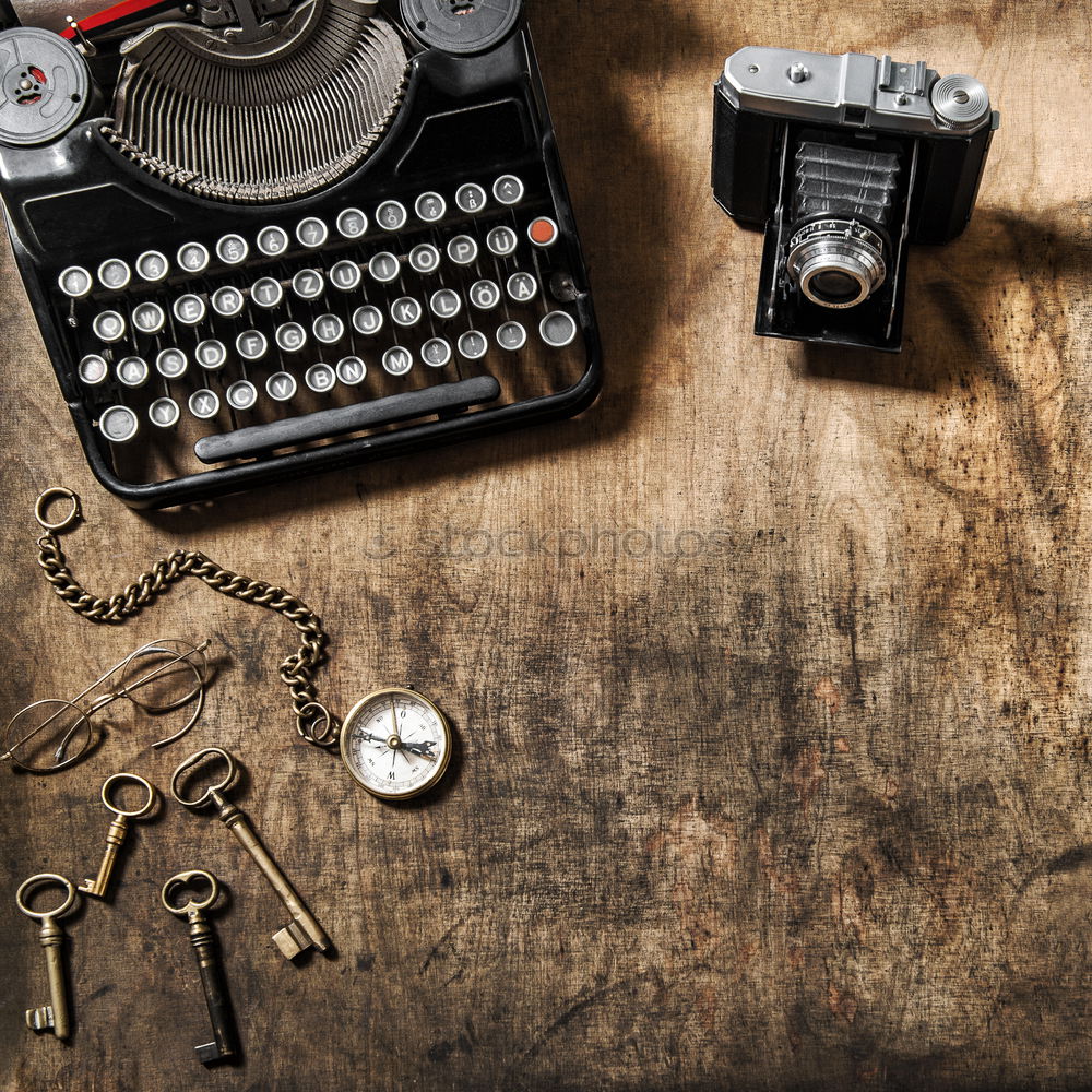 Traditional and old way of writing messages and taking photos, typewriter, camera, watch, pen, Vintage lamp on the desk