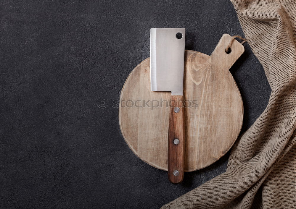 Similar – kitchen brown cutting board with handle and knife