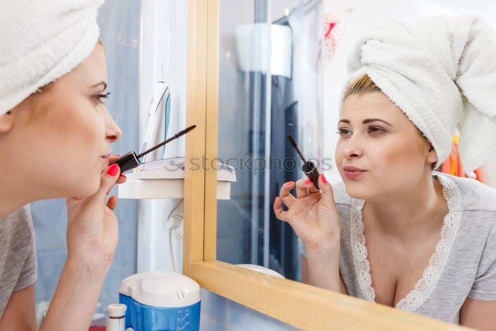 Similar – Young gender fluid person applying makeup at home