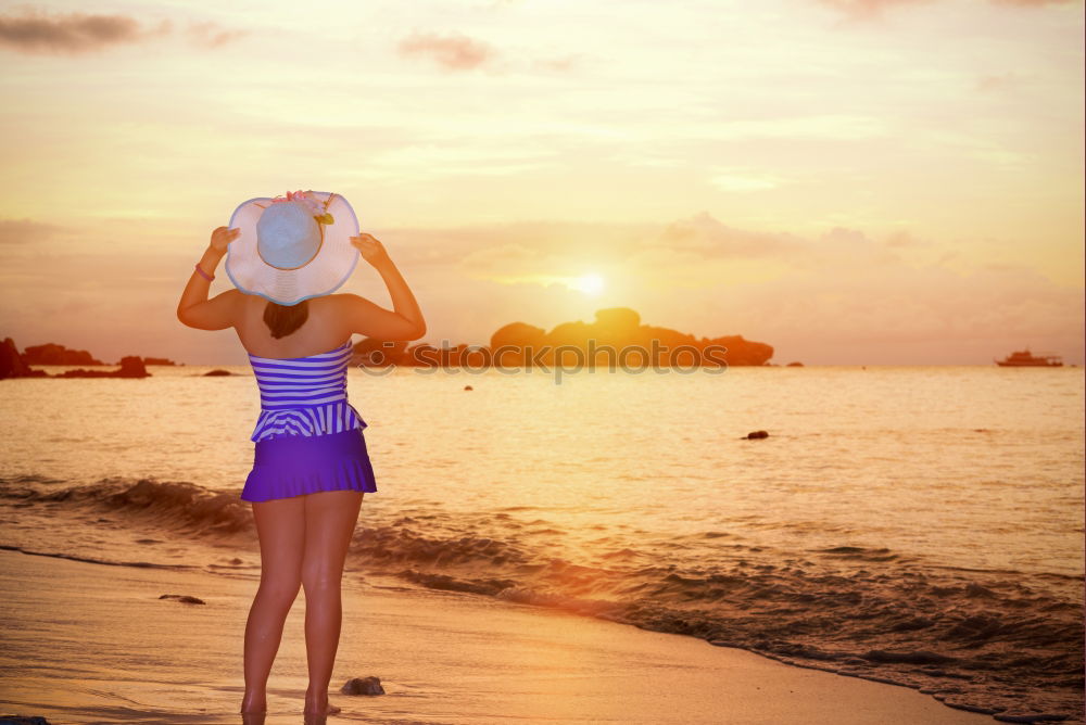 Similar – Smiling woman with sunglasses and hat raising arms happy with the sea in the background.