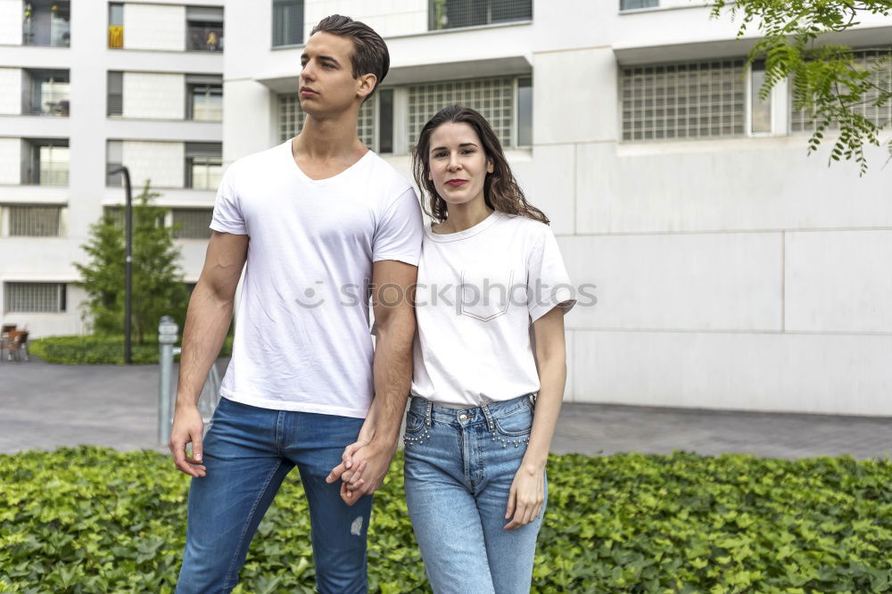 Similar – Side view Happy couple in love jumping against grey wall.