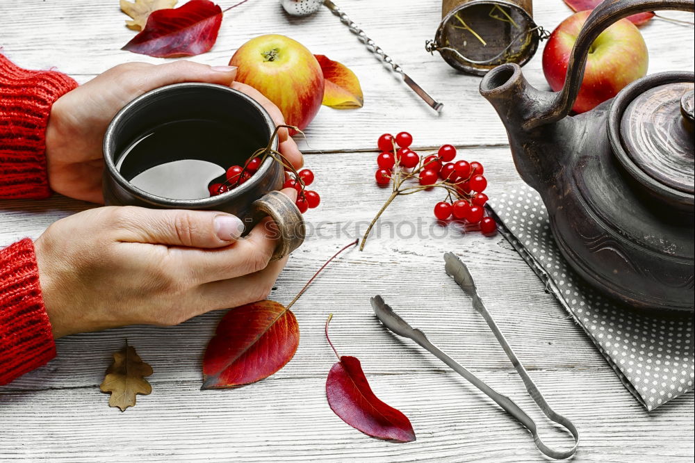 Similar – female hands holding an iron mug with carrot juice