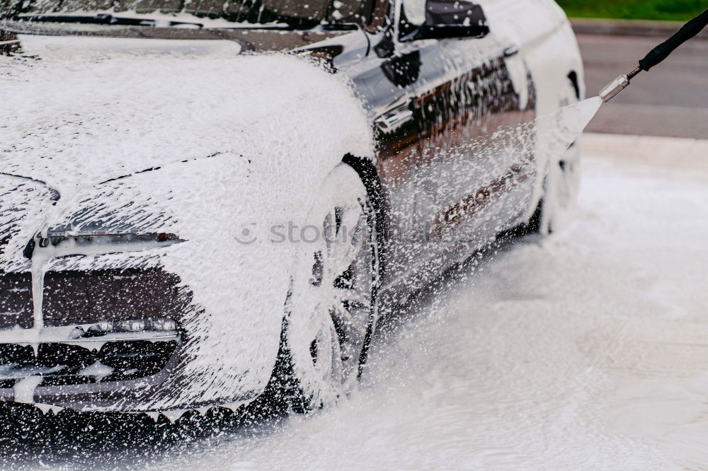 Whoosh!!! There thunders the dark car full through a deep puddle. A huge shower of water drenches the pedestrian with a colorful umbrella and red rubber boots.