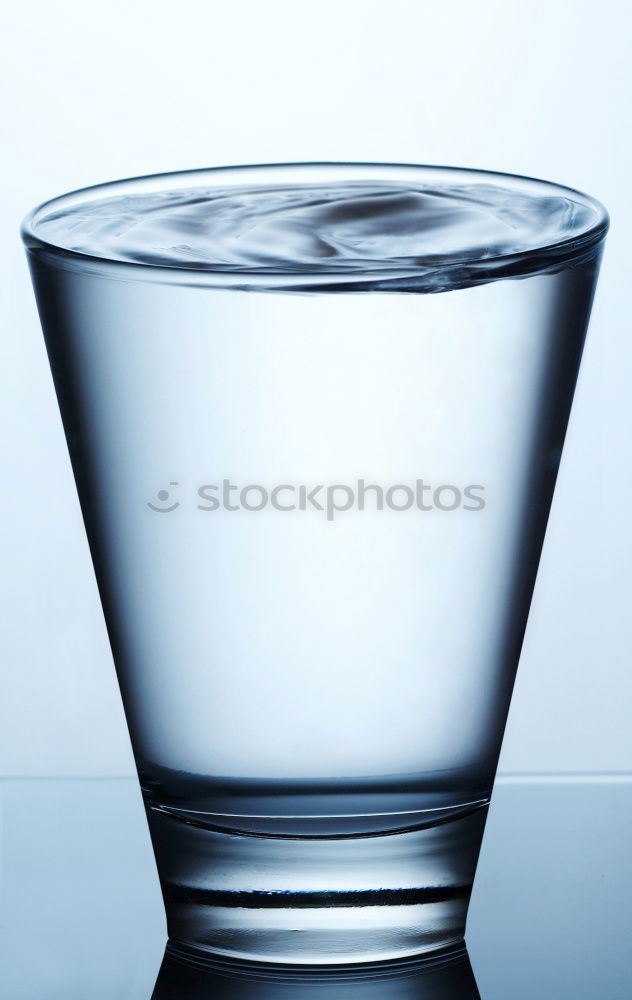 Similar – Glass filled to the brim with water in monochrome blue.