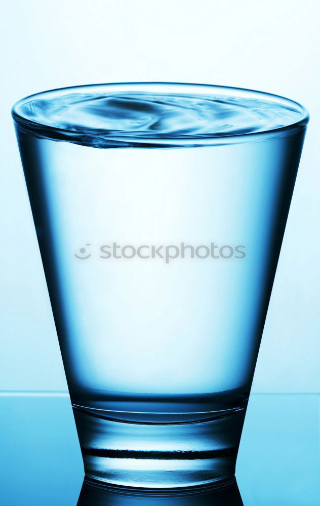 Similar – Glass filled to the brim with water in monochrome blue.