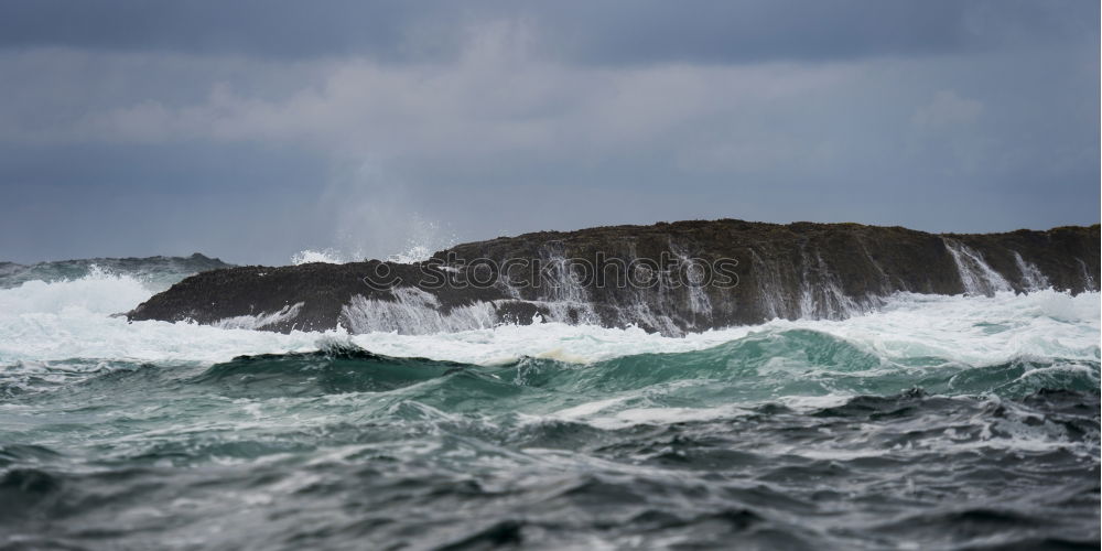 Waves of the Atlantic break foaming at the coast of Ireland