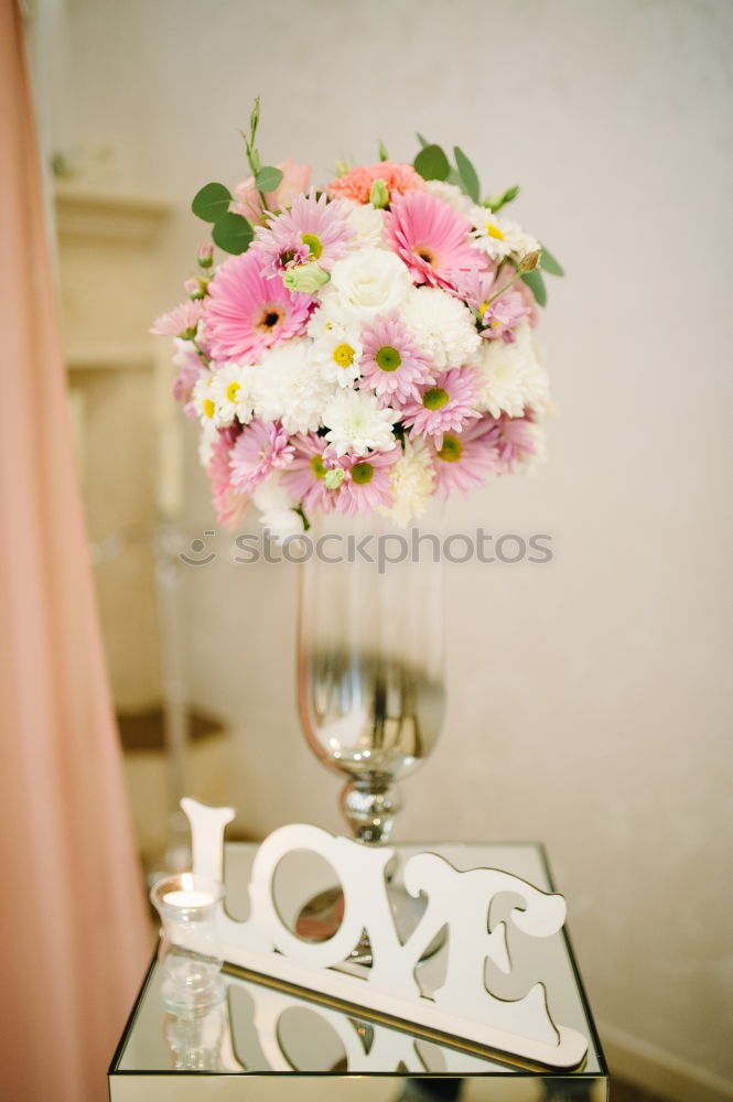 Similar – Low angle view of a pretty wedding bouquet of white flowers lying on a table top with selective focus and copyspace