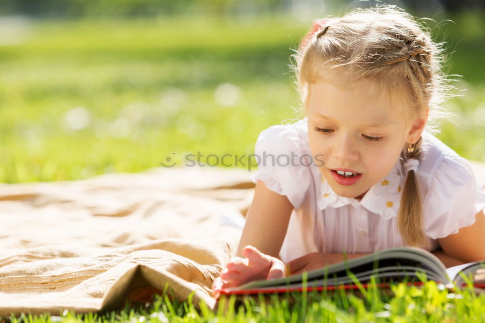 Similar – Image, Stock Photo Little baby girl watching a book with pictures