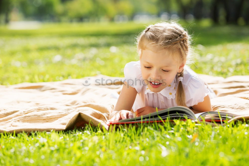 Similar – Image, Stock Photo Little baby girl watching a book with pictures