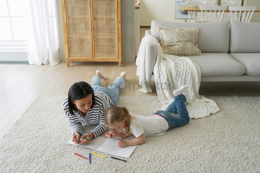 mother reading book to toddler daughter