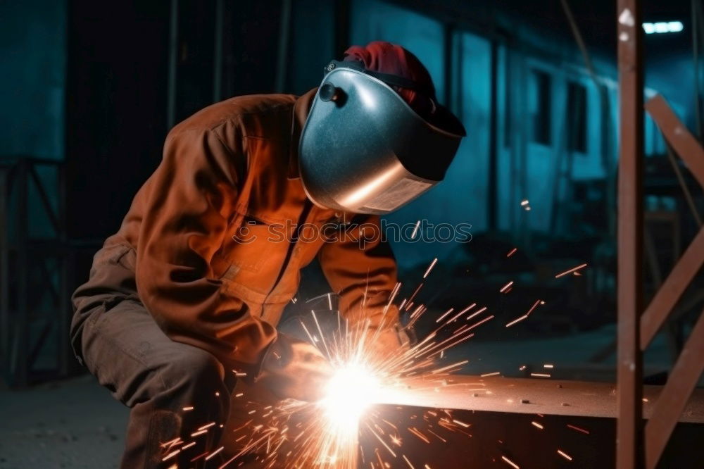 Similar – worker using an angle grinder