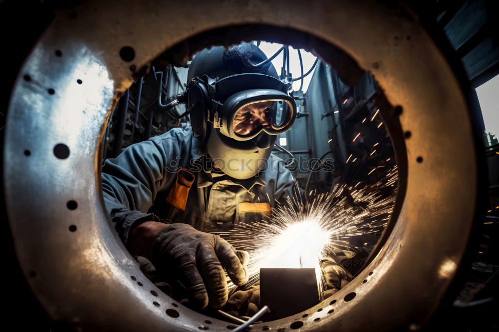 Similar – worker using an angle grinder