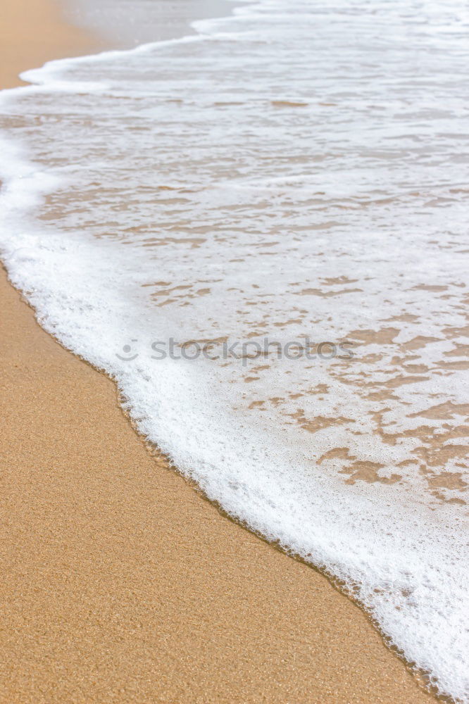 Similar – Foaming water of the Atlantic Ocean at a sandy beach