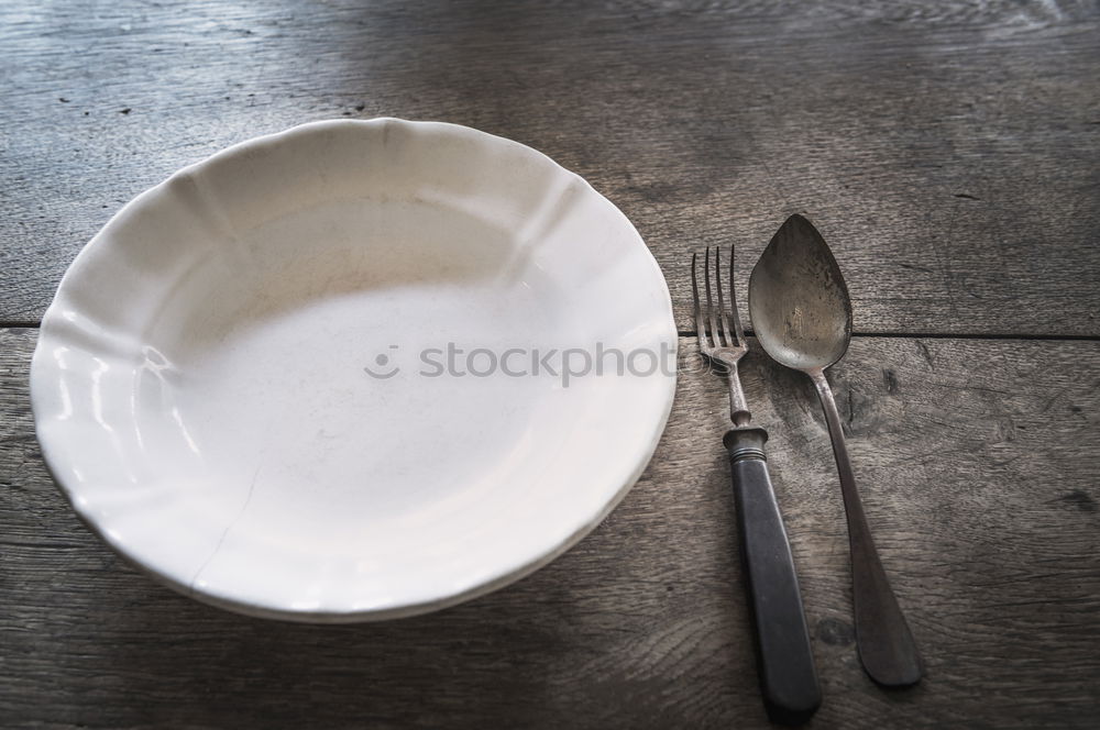 Similar – White empty plate and metal vintage knife and fork