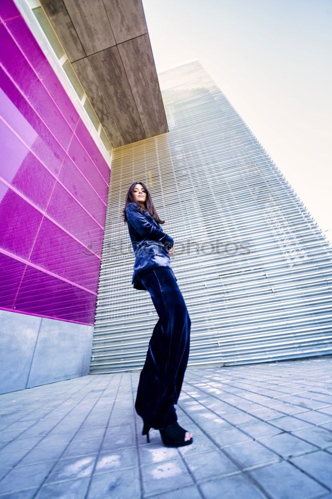 Similar – Young redhead woman leaning against a blue wall