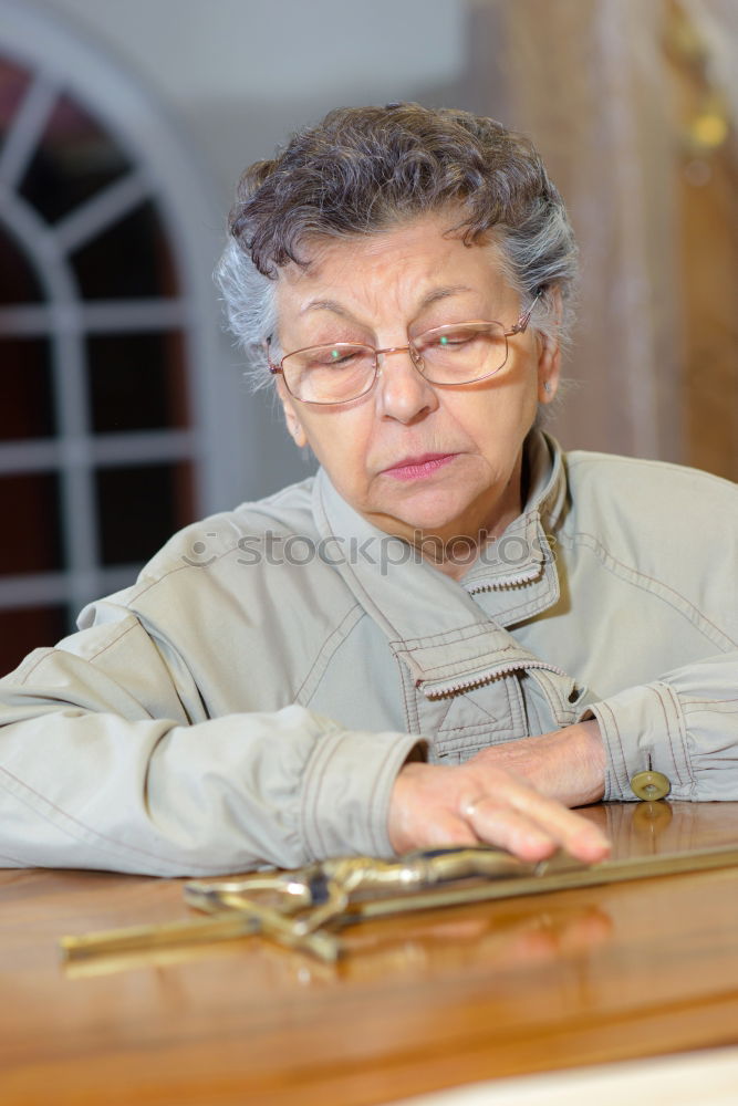 Similar – Image, Stock Photo Elderly woman wearing glasses sitting in her living room reading a letter, closeup portrait