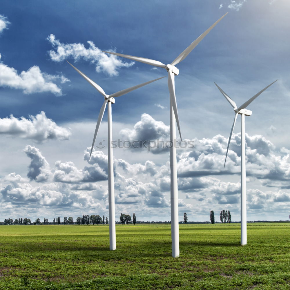 Similar – Wind turbine for renewable power generation in front of a dike on the North Sea coast, long straight road. Wind turbine