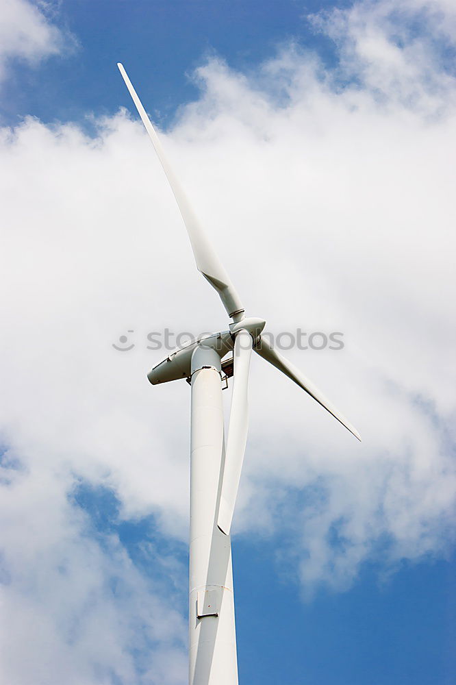 Similar – Wind turbine for renewable power generation in front of a dike on the North Sea coast, long straight road. Wind turbine