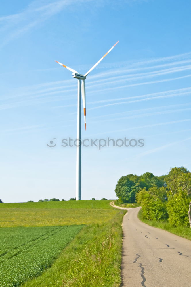 Similar – Image, Stock Photo Wind turbine for renewable power generation in front of a dike on the North Sea coast, long straight road. Wind turbine