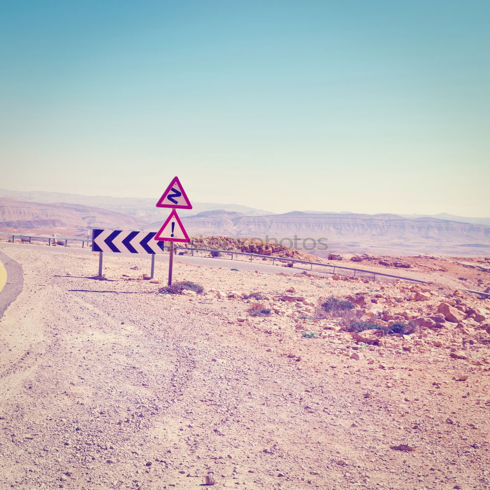 Similar – Warning sign in curve in front of alpine panorama