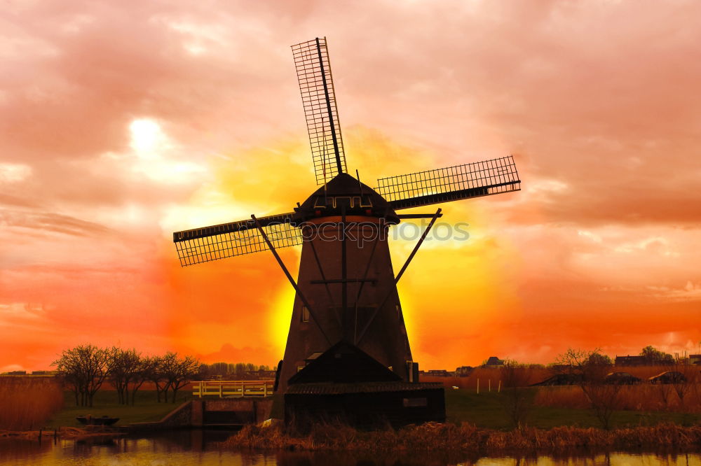 charming windmill by river at sunrise