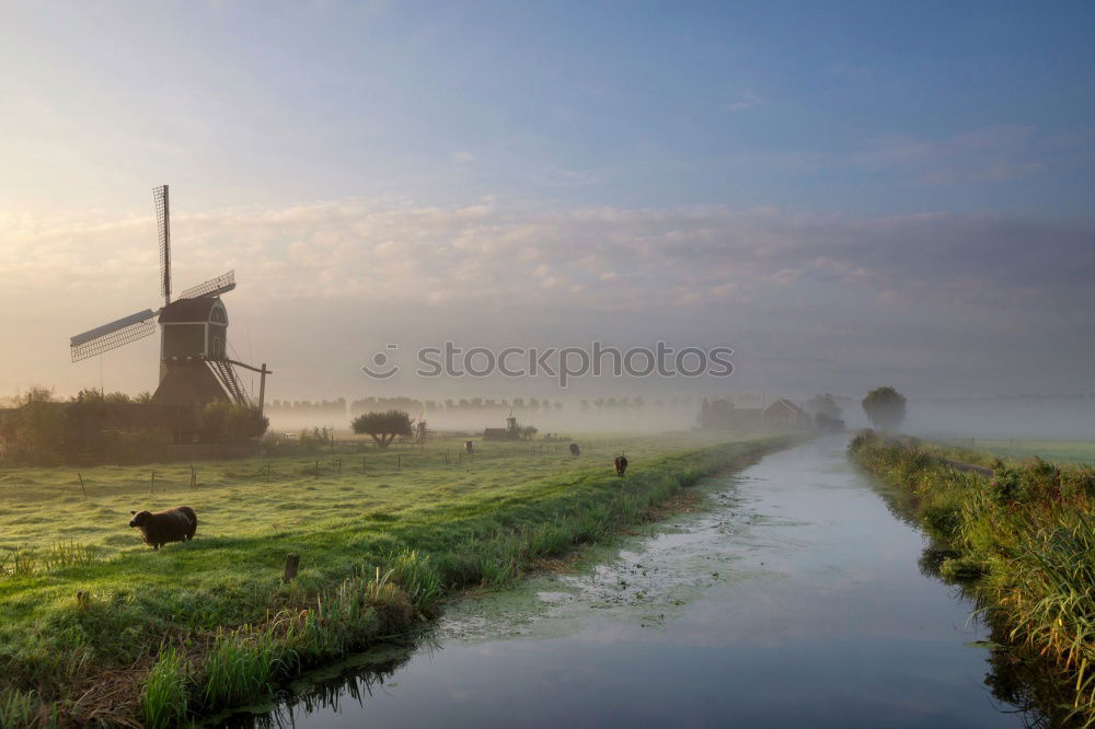 Similar – charming windmill by river at sunrise