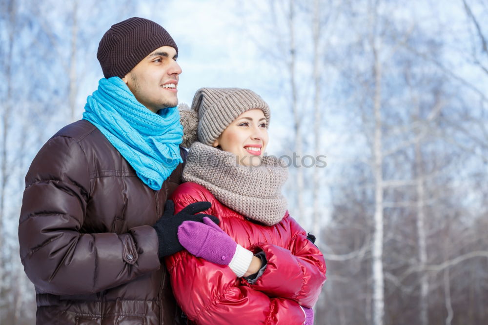 Similar – Young couple under blanket having hot drink in a cold day