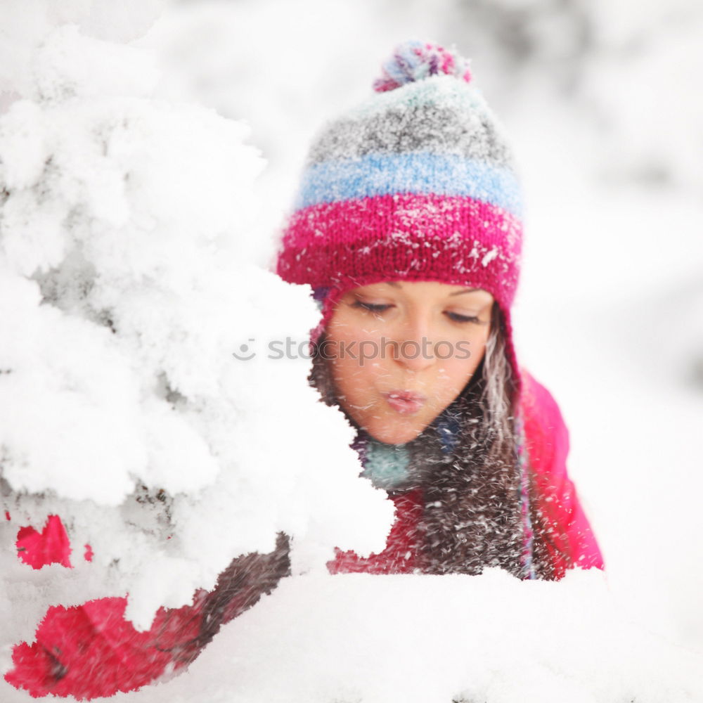 Girl and her little sister making a snowman