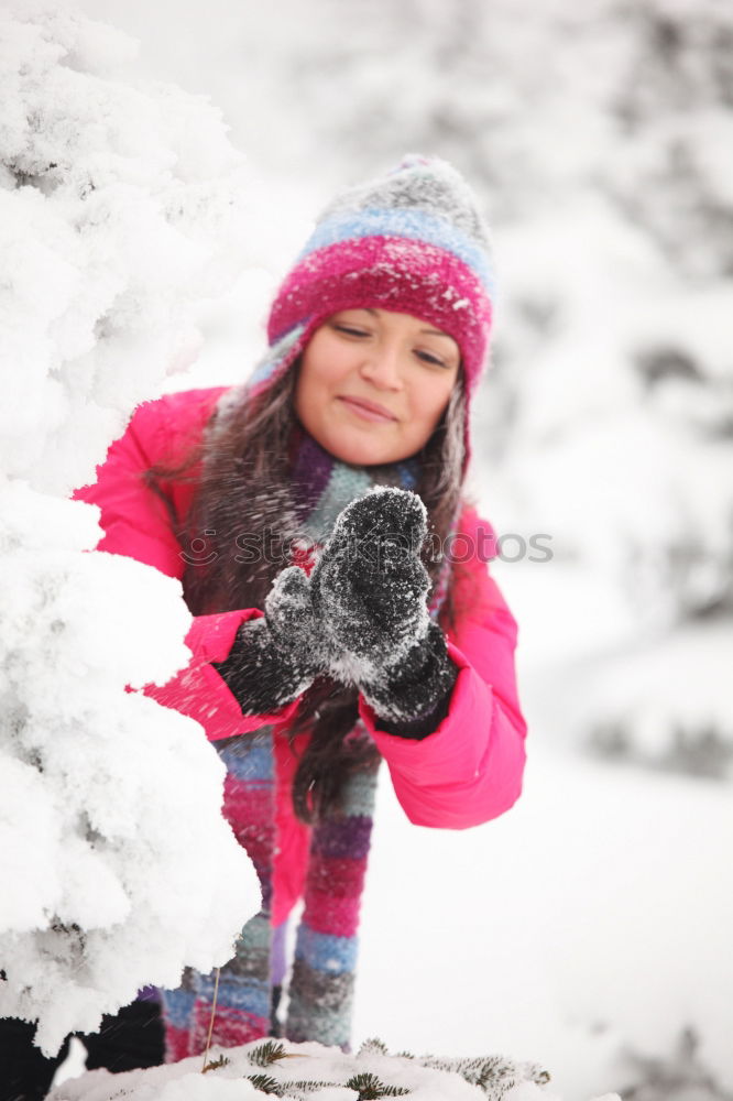 Similar – Girl and her little sister making a snowman