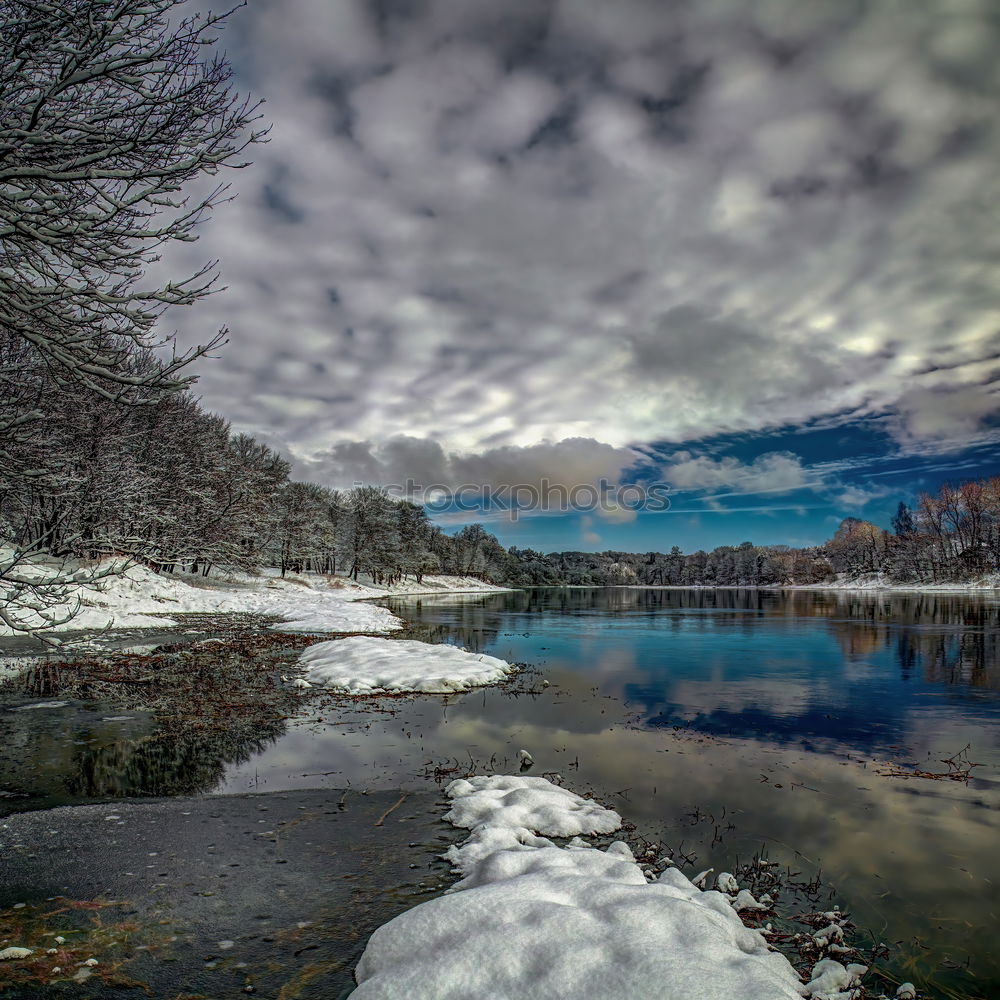 Similar – Half-frozen lake in idyllic winter landscape