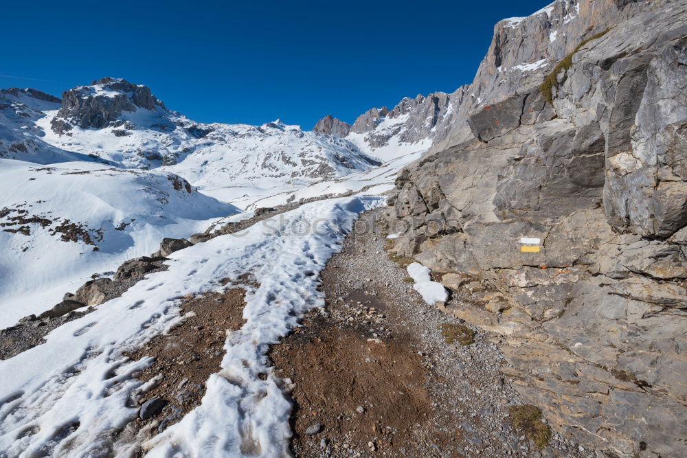 Similar – Man walking in snowy mountains