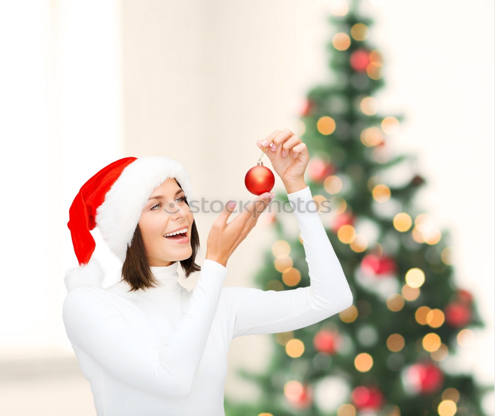 Similar – Image, Stock Photo Young girl decorating Christmas tree with lights at home