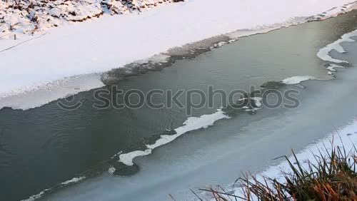 Similar – Open, thawed ice surface on a lake. Climate, climate change