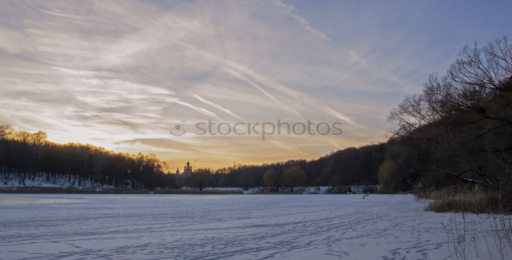 Similar – Half-frozen lake in idyllic winter landscape