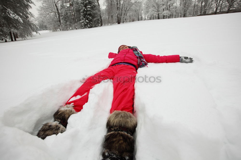 Similar – Image, Stock Photo Young cute woman lying playing and enjoying snow in winter