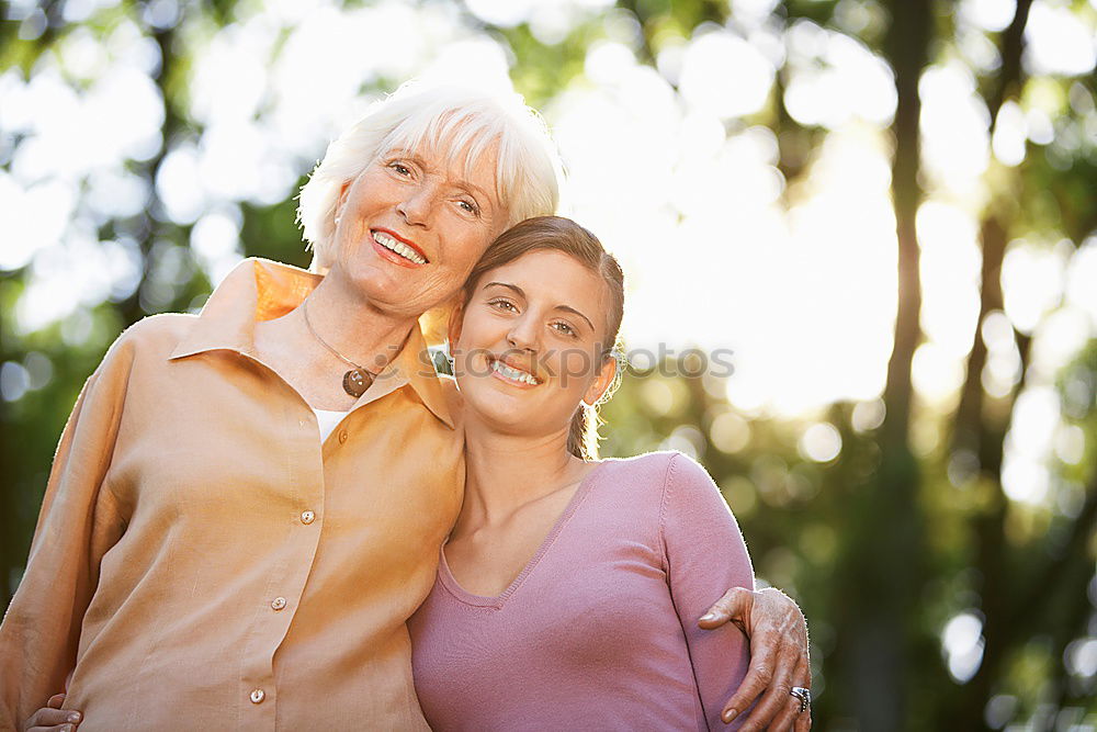 Two happy young women friends hugging in the street