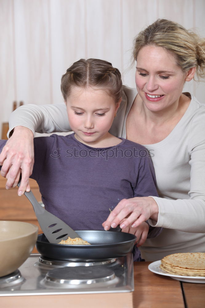 Similar – Image, Stock Photo Little sisters cooking with her mother in the kitchen.