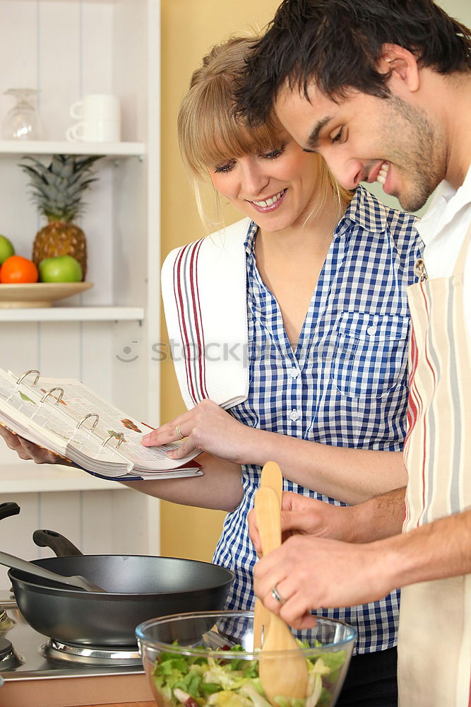 Similar – Image, Stock Photo Young couple cooking. Man and woman in their kitchen