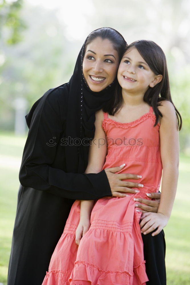 Image, Stock Photo Muslim mother holding a little baby by arms in outdoor area