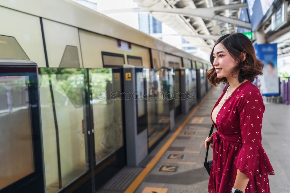 Similar – Fröhliches Mädchen steigt am Bahnhof mit Kaffee in der Hand in den Zug ein.