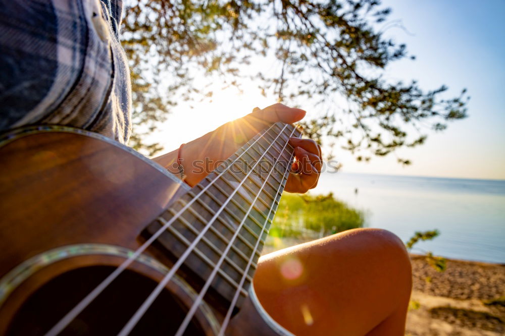 Similar – Beautiful woman playing guitar.