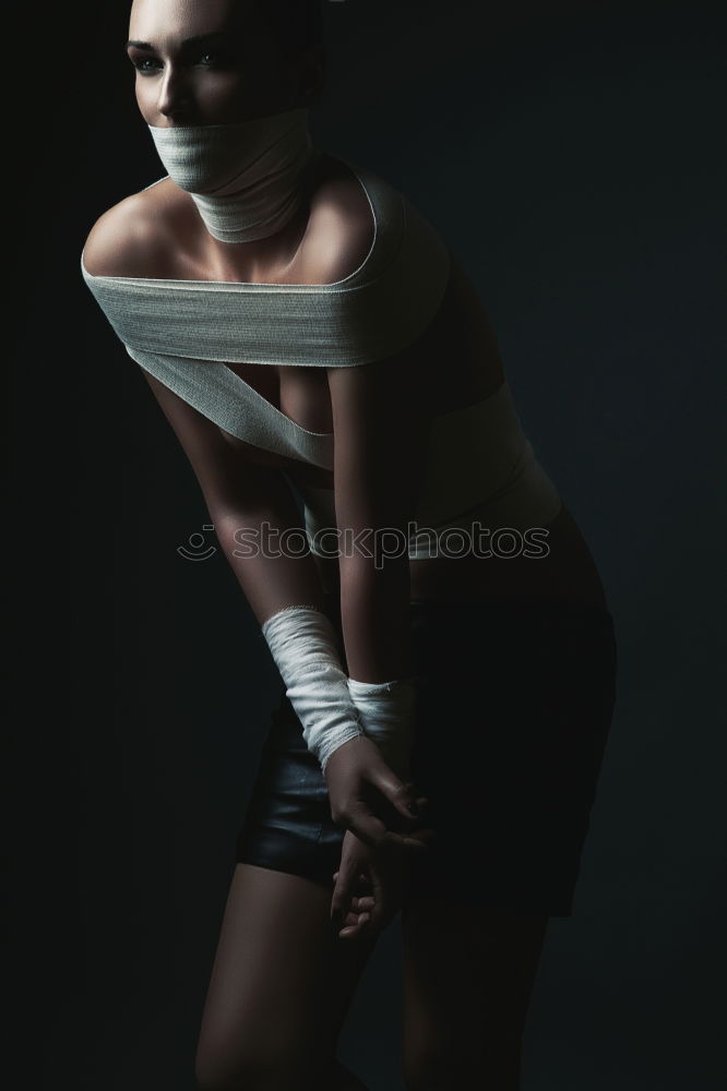 Similar – Image, Stock Photo Female figure squatting on a wooden floor with her back to the viewer; desaturated colors. Only the mouth of the face is indicated