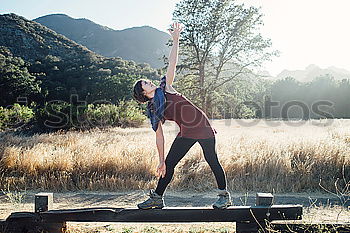 Similar – Woman stretching legs in park