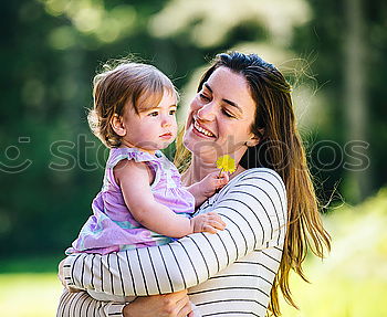 Similar – Baby girl standing on a bench hugging to woman