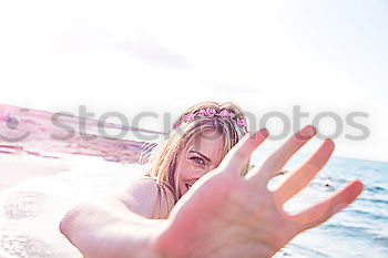 Similar – Young woman at the beach while the sunset smiling