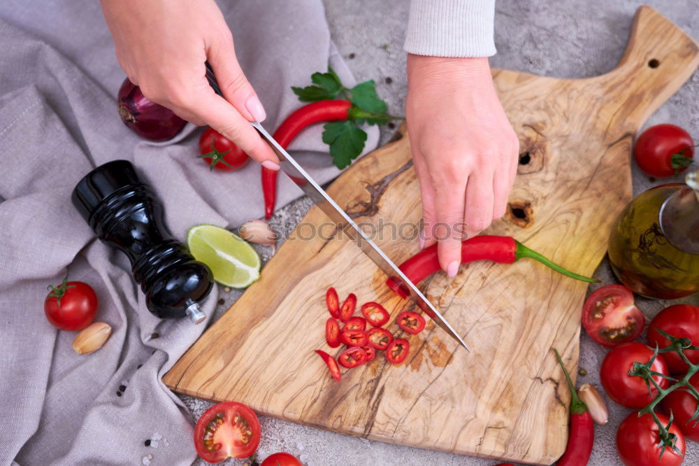 Similar – process of slicing carrots on slices on a kitchen board