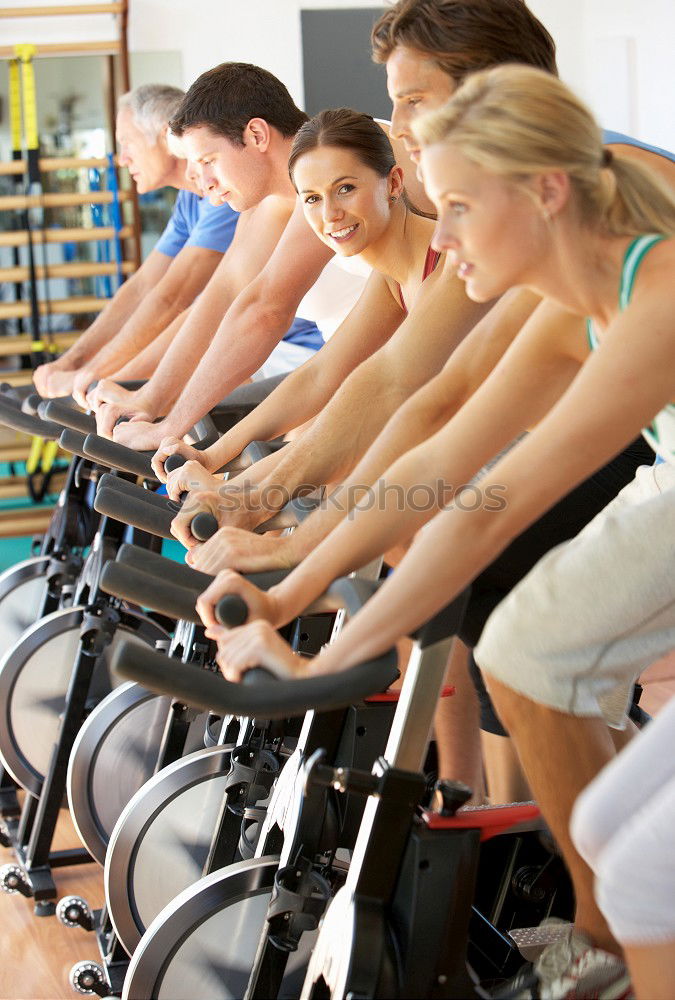 Similar – Concentrated woman in hard bike training session