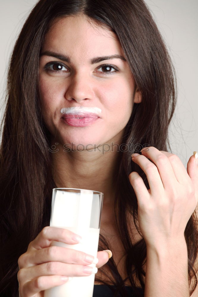 Similar – portrait of young woman eating bubble gum in brick background