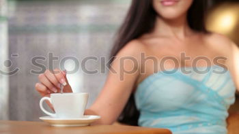 Similar – beauty girl sitting in a coffee shop with a cup in her hands