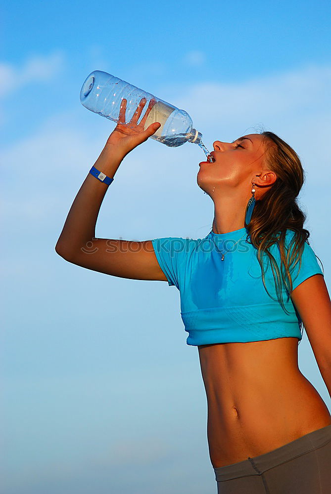 athletic woman resting and drinking